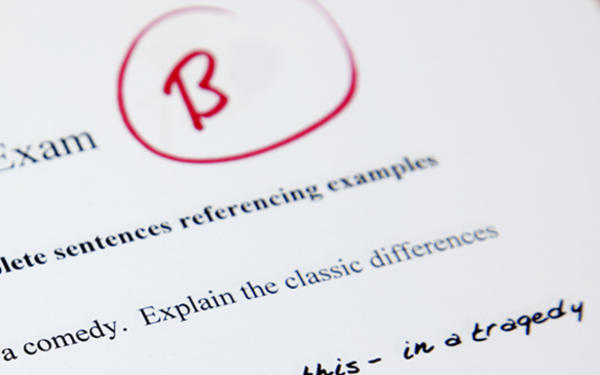 Close-up of the top of an exam paper graded with a B