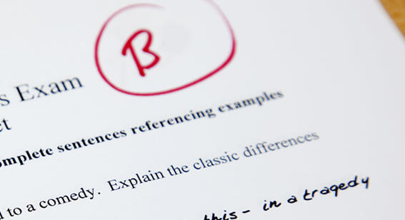 Close-up of the top of an exam paper graded with a B