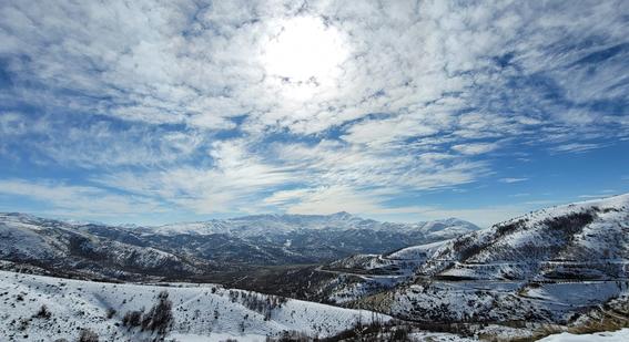 snow covered mountains under blue sky and white clouds during daytime