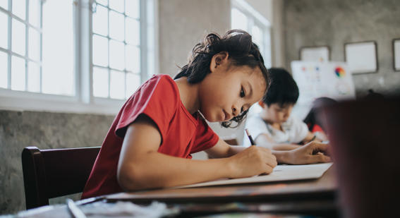 Girl in classroom writing