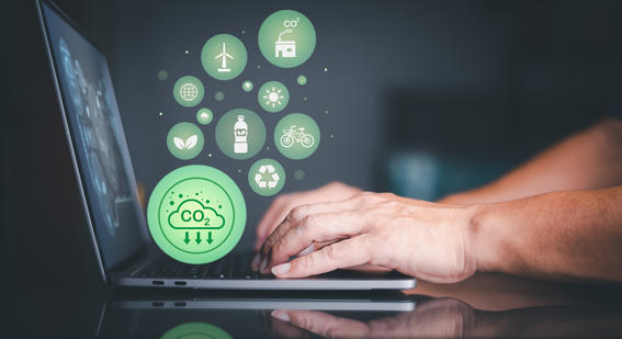 Image showing icons related to falling carbon emissions rise from a computer. 