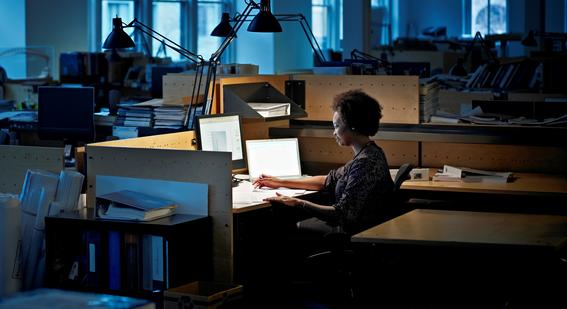 Women works at computer late at night