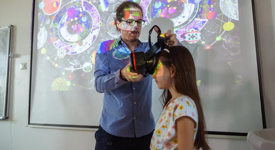 Student having a VR headset placed on her head