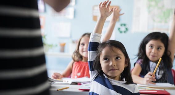 Child raising hand in class