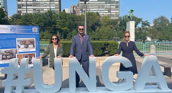 Cambridge colleagues behind a #UNGA sign