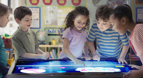 Children looking at interactive table