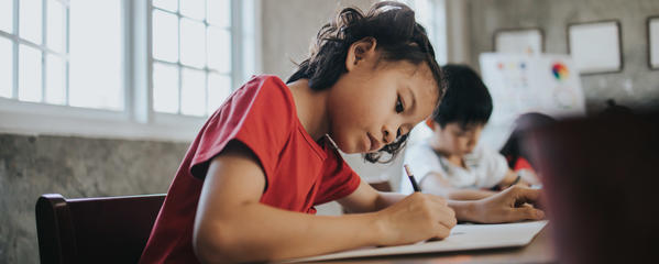 Girl in classroom writing