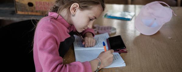 Young girl writing in a notebook